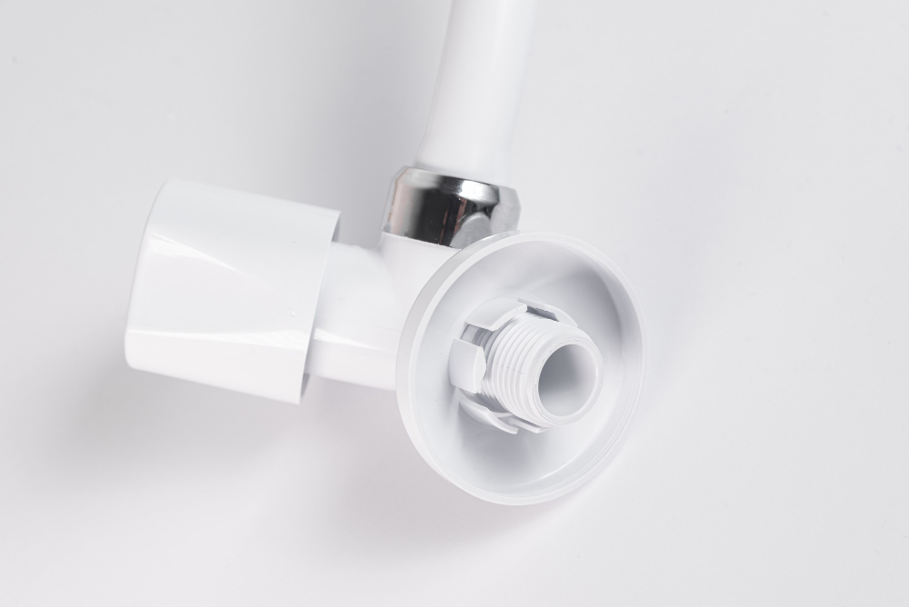 Close-up of a white plastic plumbing valve.