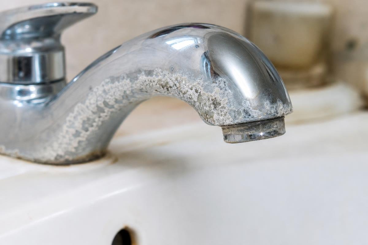 hard water mineral buildup on faucet fixture in Redwood Valley home