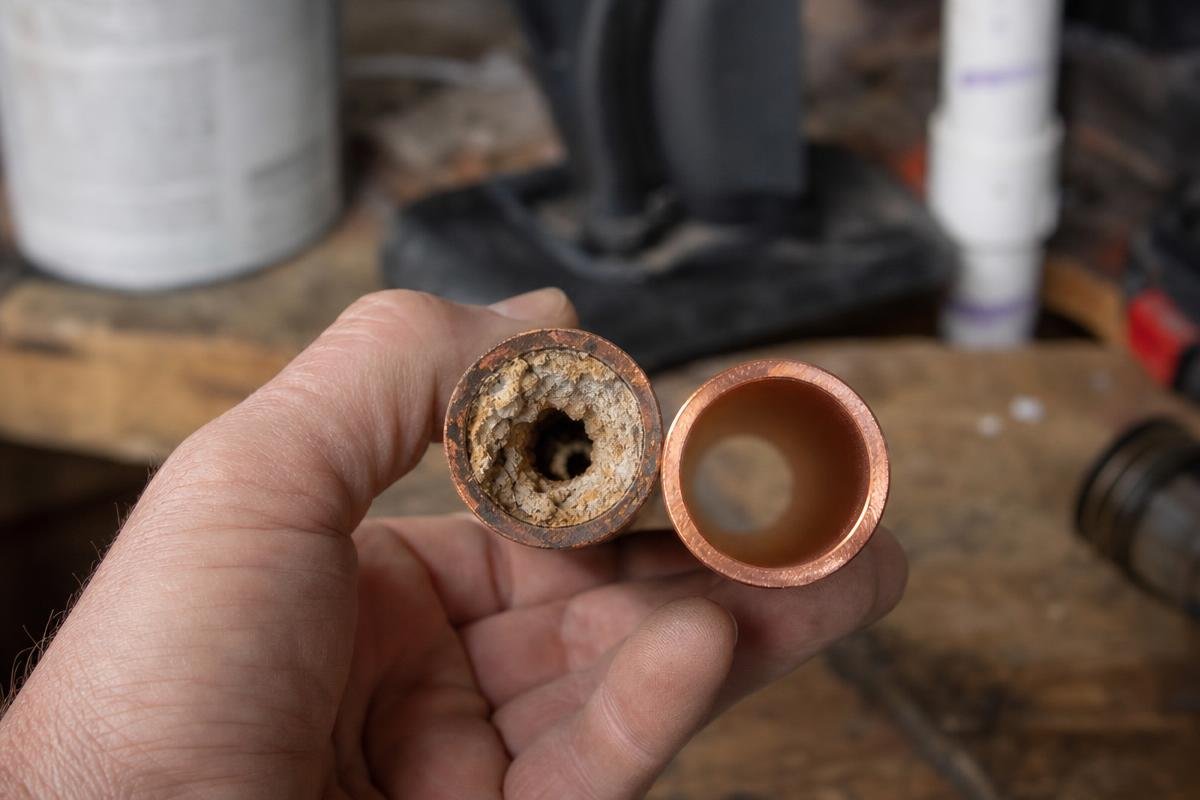 mineral buildup inside copper pipe from hard water damage