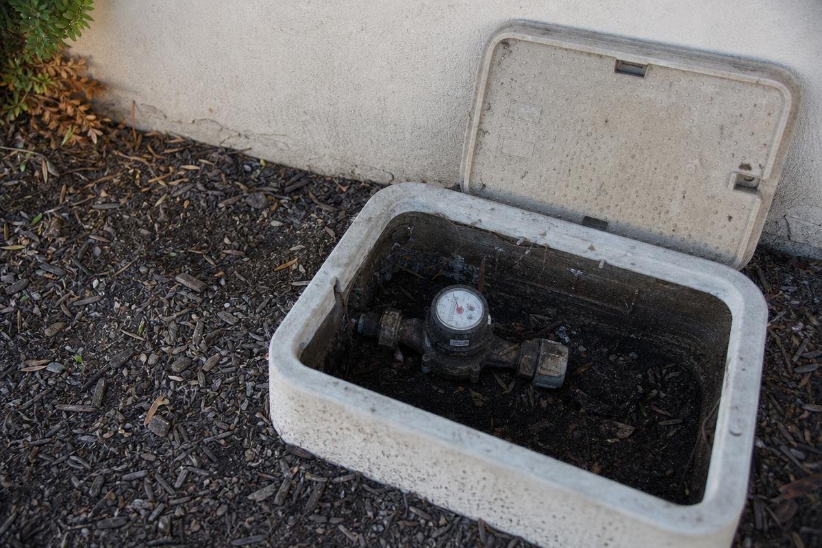 Outdoor water meter inside an open utility box